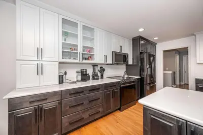 a large kitchen with white cabinets and a counter top at Big Sky Retreat - Home for 10 in Fairfield