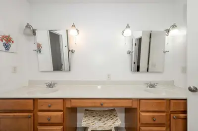a bathroom with two sinks and two mirrors at Big Sky Retreat - Home for 10 in Fairfield