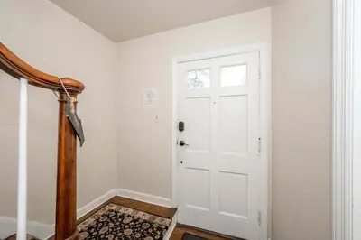 a hallway with a white door and a rug at Kenwood Keys Suites - for 12 in Cincinnati