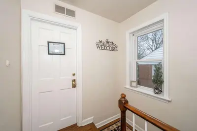 a white door in a hallway with a window at Kenwood Keys Suites - for 12 in Cincinnati