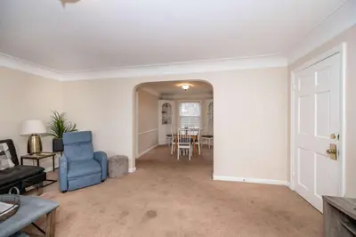 a living room with a blue chair and a table at Kenwood Keys Suites - for 12 in Cincinnati