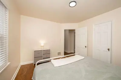 a bedroom with a bed and a dresser and a window at Kenwood Keys 1 - Cozy Stay for 6 in Cincinnati
