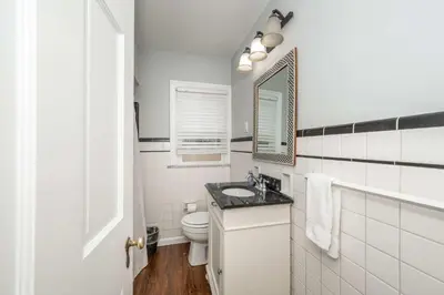 a white bathroom with a toilet and a sink at Kenwood Keys 1 - Cozy Stay for 6 in Cincinnati