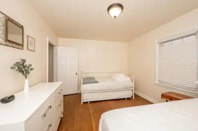 a white bedroom with a bed and a window at Kenwood Keys 1 - Cozy Stay for 6 in Cincinnati
