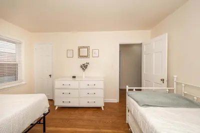 a bedroom with two beds and a white dresser at Kenwood Keys 1 - Cozy Stay for 6 in Cincinnati