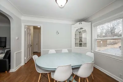 a dining room with a blue table and white chairs at Kenwood Keys 1 - Cozy Stay for 6 in Cincinnati