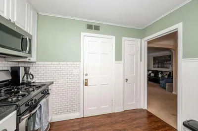 a kitchen with green walls and a white door at Kenwood Keys 2 - Stay for 6 in Cincinnati