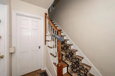a hallway with a stairway with a white door at Kenwood Keys 2 - Stay for 6 in Cincinnati