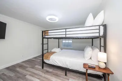 a bedroom with a bunk bed and a table at Stillwater Hollow - For 10! in Williamstown