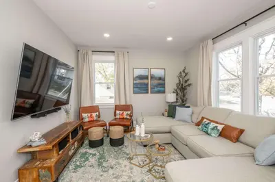 a living room with a couch and a tv at Bridgetown Bungalow in Cincinnati