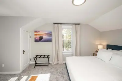 a bedroom with a white bed and a window at Bridgetown Bungalow in Cincinnati