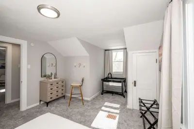 a bedroom with a dresser and a mirror at Bridgetown Bungalow in Cincinnati