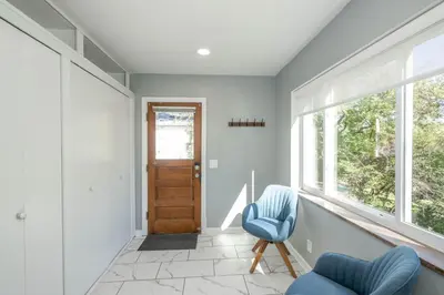 a hallway with two blue chairs and a door at Love 'n Life Haven in Cincinnati