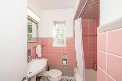 a pink bathroom with a toilet and a sink at Love 'n Life Haven in Cincinnati