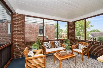 a porch with chairs and a couch and a table at The Cincinnati Charm in Cincinnati