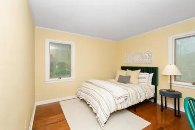 a bedroom with a bed and two windows at The Cincinnati Charm in Cincinnati
