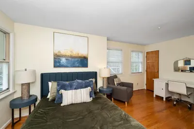 a bedroom with a bed and a desk and chairs at The Cincinnati Charm in Cincinnati