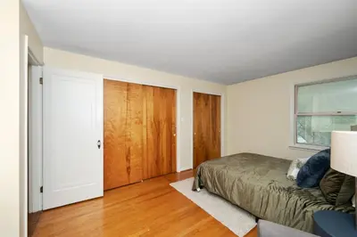 a bedroom with a bed and a sliding door at The Cincinnati Charm in Cincinnati