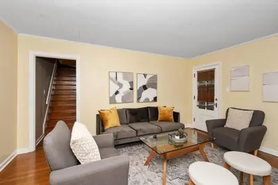a living room with a couch and chairs and a table at The Cincinnati Charm in Cincinnati