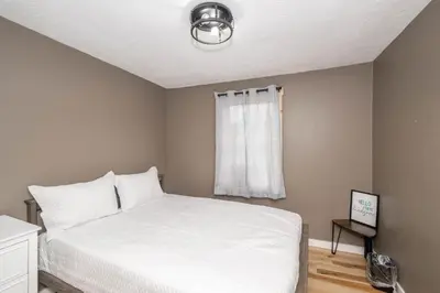 a bedroom with a white bed and a window at The Ark Encounter Getaway in Williamstown