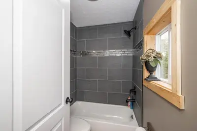 a bathroom with a white tub and a toilet at The Ark Encounter Getaway in Williamstown