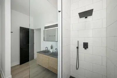 a bathroom with a sink and a glass shower at Heights on Wayne by Blackhouse in Cincinnati