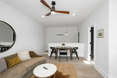 a living room with a couch and a ceiling fan at Heights on Wayne by Blackhouse in Cincinnati