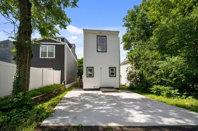 a driveway leading to a white house with a fence at Heights on Wayne by Blackhouse in Cincinnati