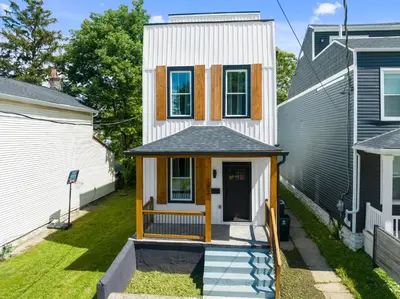 a tiny house with a porch in a yard at Heights on Wayne by Blackhouse in Cincinnati