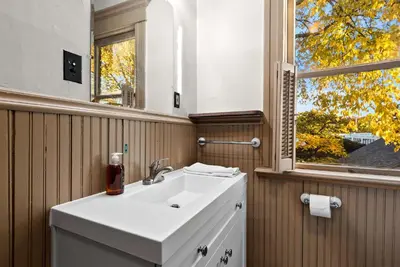 a bathroom with a white sink and a window at Bella Notte Columbus in Columbus