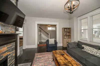 a living room with a couch and a table at The Restful Roost w Hot Tub in Columbus