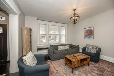 a living room with a couch and two chairs and a table at The Restful Roost w Hot Tub in Columbus