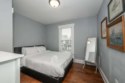 a small bedroom with a bed and a window at The Restful Roost w Hot Tub in Columbus