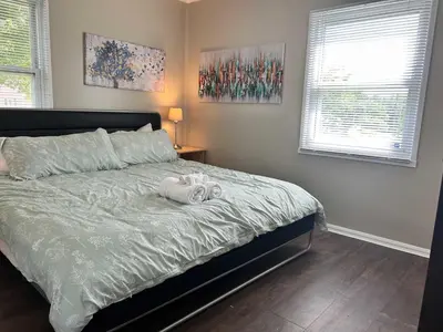 a bedroom with a bed with a towel on it at Bellwood 2 bed family house w 2 living areas Superhost in Loveland