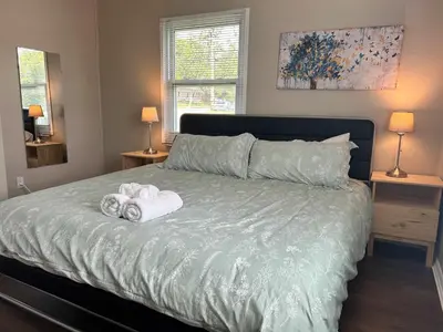 a bedroom with a bed with towels on it at Bellwood 2 bed family house w 2 living areas Superhost in Loveland
