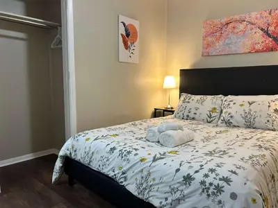 a bedroom with a bed with towels on it at Bellwood 2 bed family house w 2 living areas Superhost in Loveland