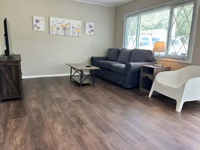 a living room with a couch and a table at Bellwood 2 bed family house w 2 living areas Superhost in Loveland