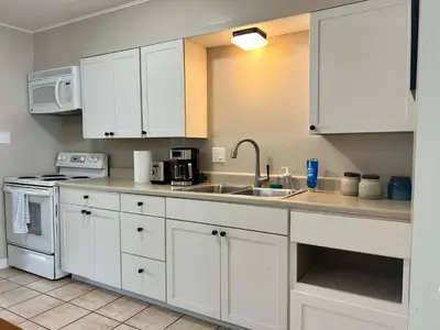 a kitchen with white cabinets and a sink at Bellwood 2 bed family house w 2 living areas Superhost in Loveland