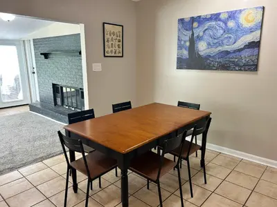 a dining room table with chairs and a painting on the wall at Bellwood 2 bed family house w 2 living areas Superhost in Loveland