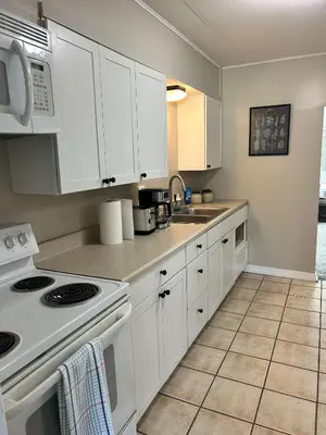 a kitchen with white cabinets and a white stove top oven at Bellwood 2 bed family house w 2 living areas Superhost in Loveland