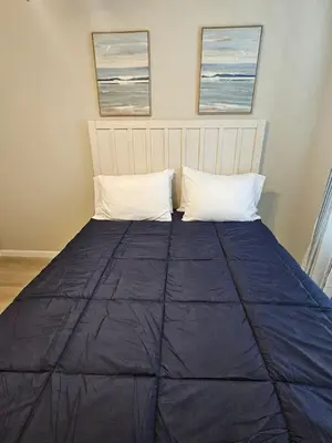 a bed with two pillows on top of it at New Construction 4 Bedroom Ranch in Trenton in Trenton