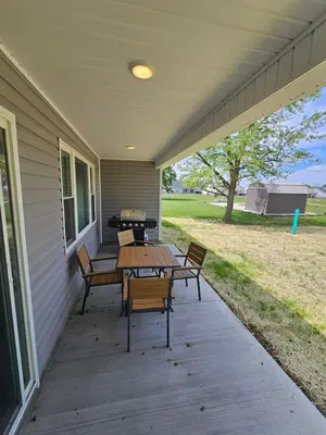 a patio with benches and a grill on a house at New Construction 4 Bedroom Ranch in Trenton in Trenton