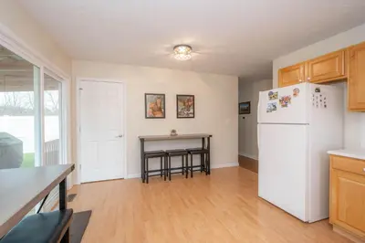 a kitchen with a white refrigerator and a table at Horse Haven - 4 BDR Charmer Close to Ark Encounter in Williamstown