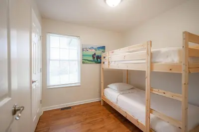 a bedroom with two bunk beds and a window at Horse Haven - 4 BDR Charmer Close to Ark Encounter in Williamstown
