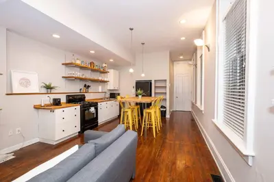 a kitchen and living room with a couch and a table at Loft Life Pendleton 2 - Chic Downtown Condo for 4 in Cincinnati