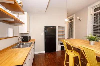 a kitchen with a black refrigerator and a wooden counter top at Loft Life Pendleton 2 - Chic Downtown Condo for 4 in Cincinnati
