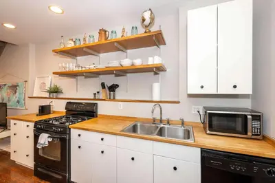 a kitchen with a sink and a microwave at Loft Life Pendleton 2 - Chic Downtown Condo for 4 in Cincinnati