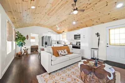 a living room with a couch and a table at 5 Neighboring Cabins at Eden Reserve - Front Five in Williamstown