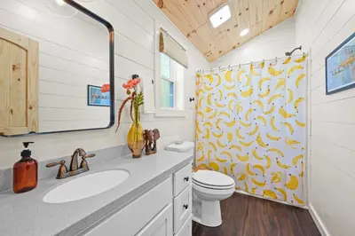 a bathroom with a toilet and a shower curtain at 5 Neighboring Cabins at Eden Reserve - Front Five in Williamstown