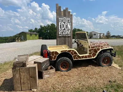a jeep parked in front of a sign at 5 Neighboring Cabins at Eden Reserve - Front Five in Williamstown